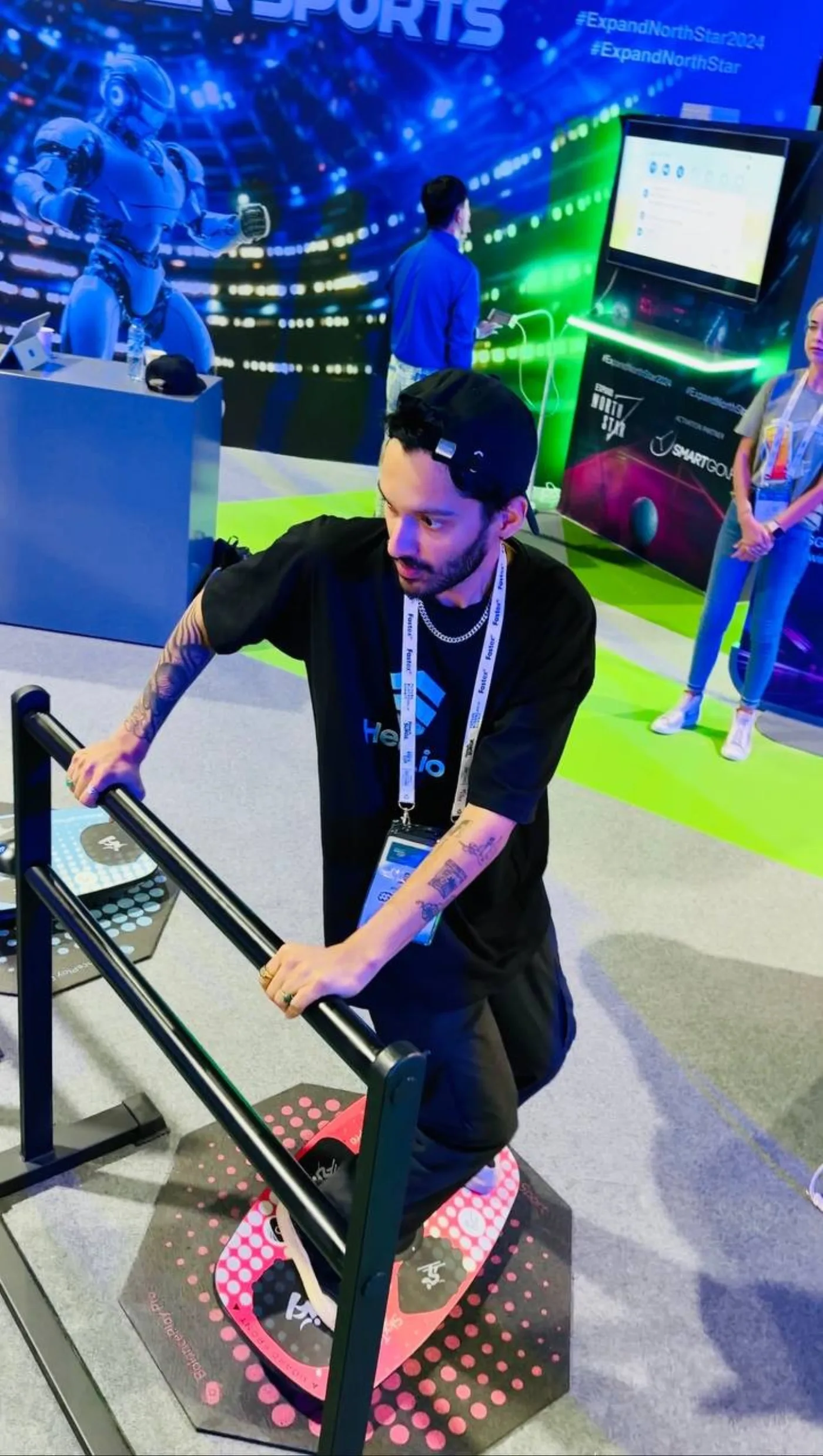 A guest riding a BalancePlay Pro smart balance board at an esports expo