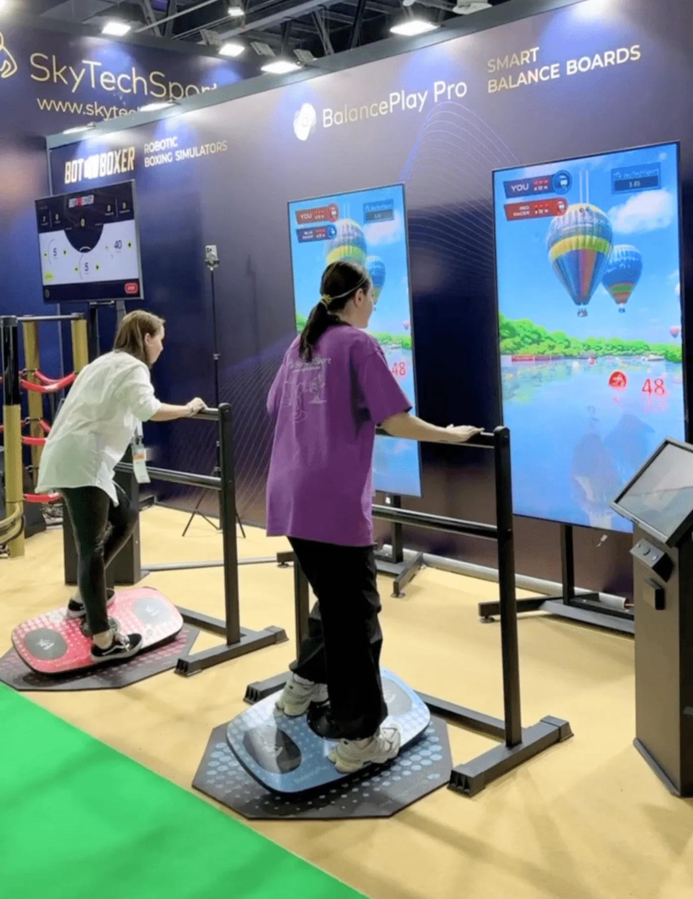 Attendees competing on BalancePlay Pro smart balance boards at a trade show