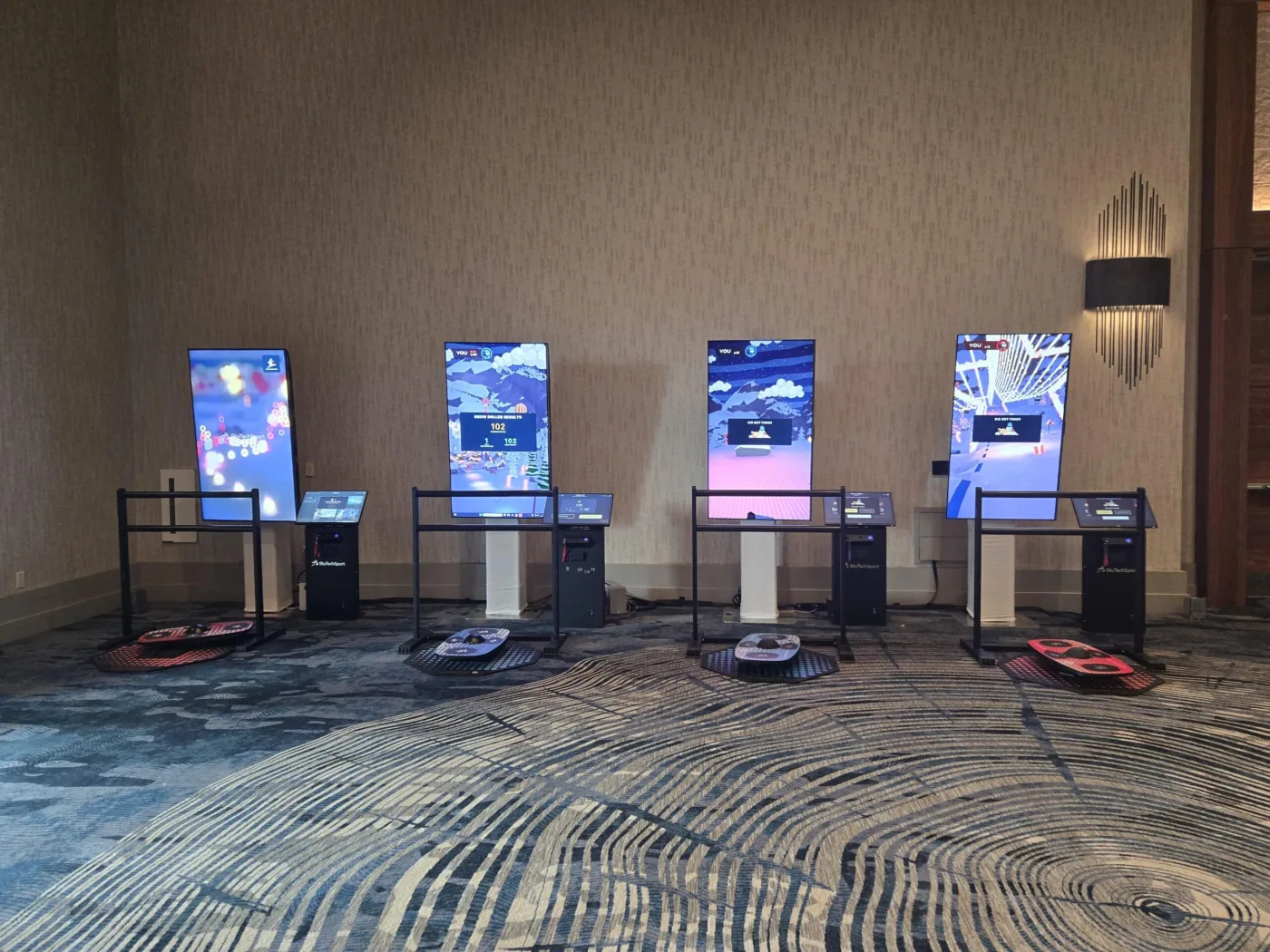 Guests playing BalancePlay Pro on smart balance boards in a corporate lobby